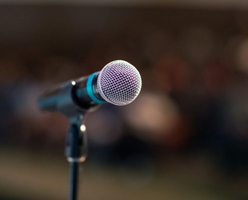 an image of a microphone before someone does a speech