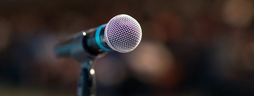 an image of a microphone before someone does a speech