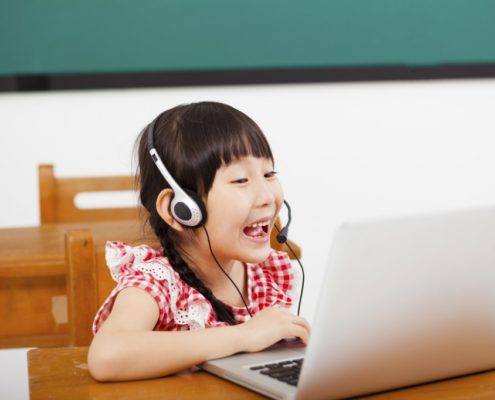 a bilingual child at home on a laptop