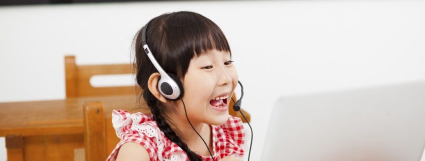 a bilingual child at home on a laptop