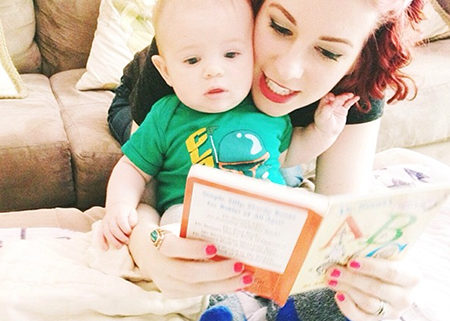 An adult and baby playing speech games at home