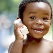 a toddler on the phone smiling