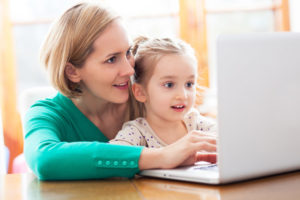 mother and daughter doing online speech therapy
