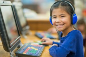 girl with a speech disorder on a computer
