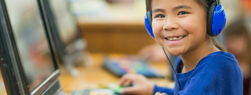 girl with a speech disorder on a computer