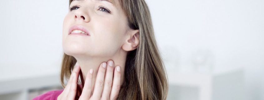 woman massaging her vocal nodules
