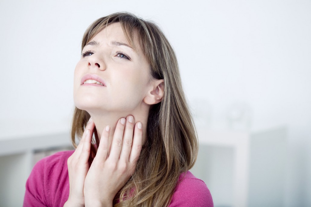 woman massaging her vocal nodules