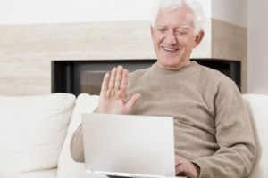 a man with Alzheimer's doing online speech therapy