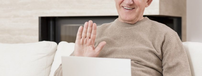 a man with Alzheimer's doing online speech therapy