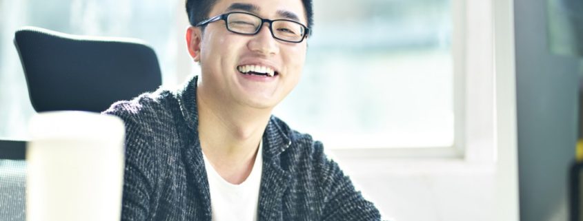 a man laughing with social communication disorder