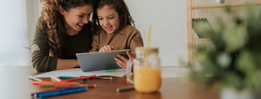 child with a parent learning at home during the pandemic