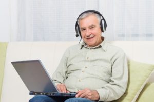 a stroke victim at home on a laptop getting help