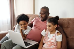 a family on a home computer with questions about speech therapy