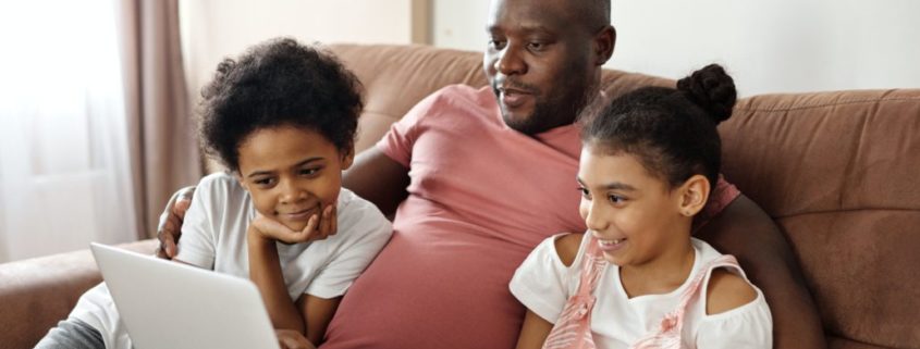 a family on a home computer with questions about speech therapy