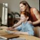 a parent helping their child learn at home online during the pandemic
