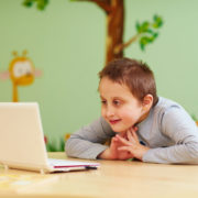 a boy with Asperger's syndrome at home doing online speech therapy