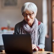 a woman on a laptop with Parkinson's Disase