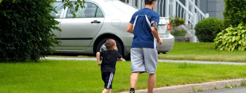 father and son communicating while jogging