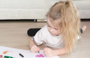 a young child drawing by herself