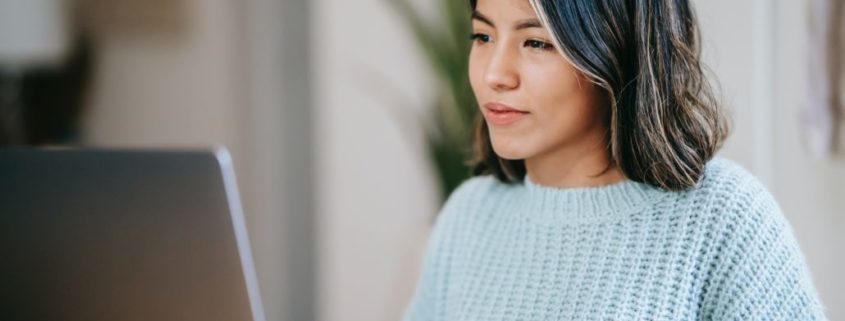 woman with Orofacial-Myofunctional-Disorder on her laptop at home