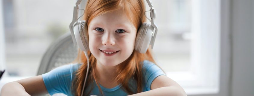 A child at home doing PROMPT therapy on her laptop