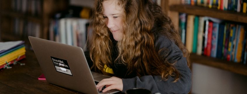 child on laptop doing speech therapy