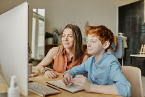 A child at home working on his stutter with an online speech therapist