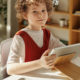 a child at home doing speech therapy exercises online