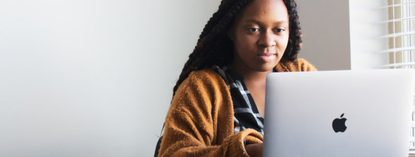 a bilingual person at home on a laptop