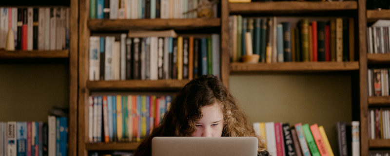 a child with autism researching at home on a laptop