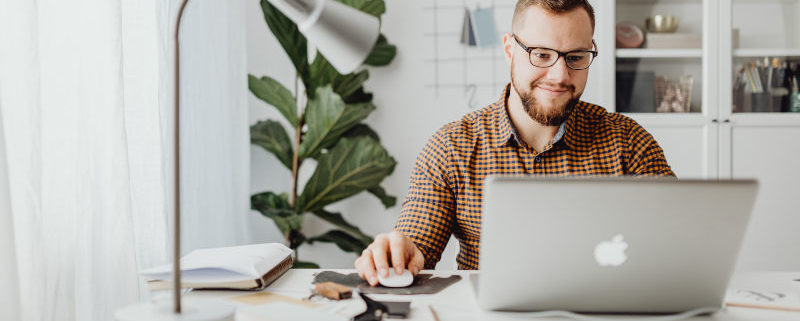 man at home on a laptop learning about speech therapy