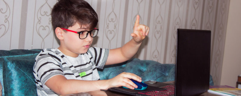 a child at home doing online speech therapy