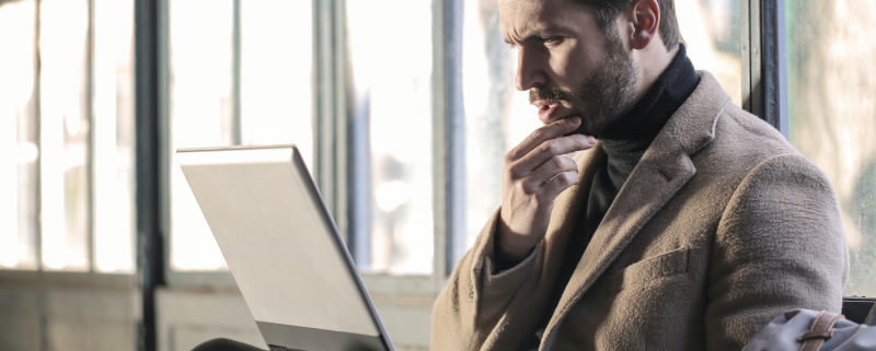 a man on his laptop that suffers pressured speech