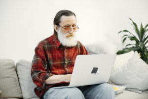 a man suffering alzheimers disease at home on his computer