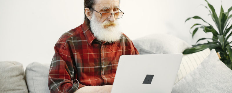 a man suffering alzheimers disease at home on his computer