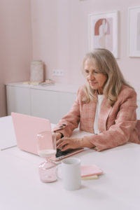 woman at home on her laptop working on her cognitive communication