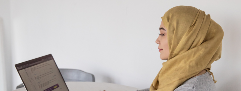 a woman at home getting voice therapy from her laptop