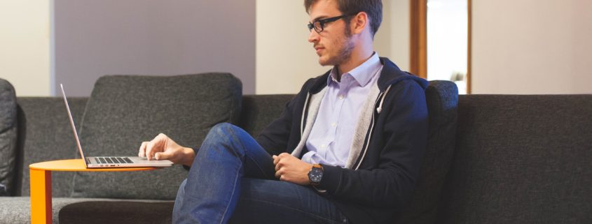 a man at home on his couch working on his communication skills