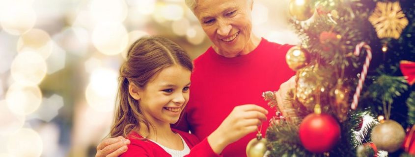 grandmother and granddaughter at christmas tree