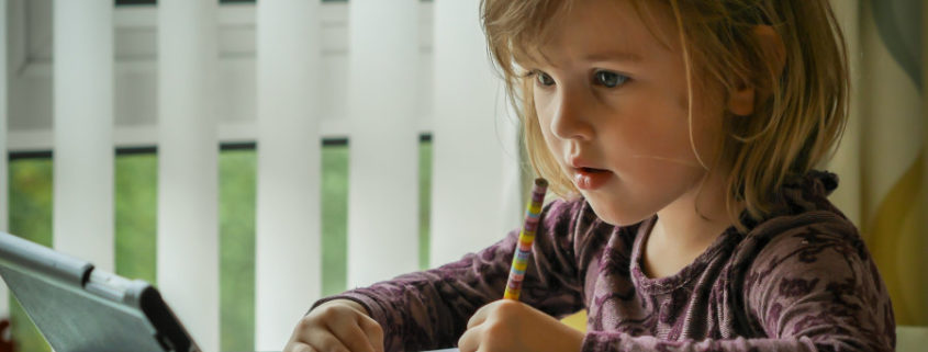 a child with a lisp learning on a tablet computer