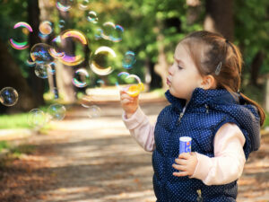 a child blowing bubbles