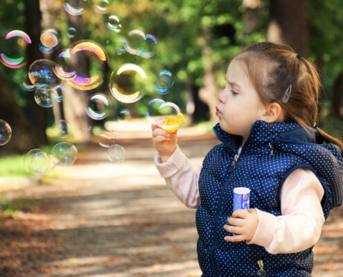 a child blowing bubbles