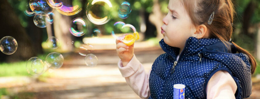 a child blowing bubbles