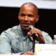 jamie foxx on a microphone speaking to an audience