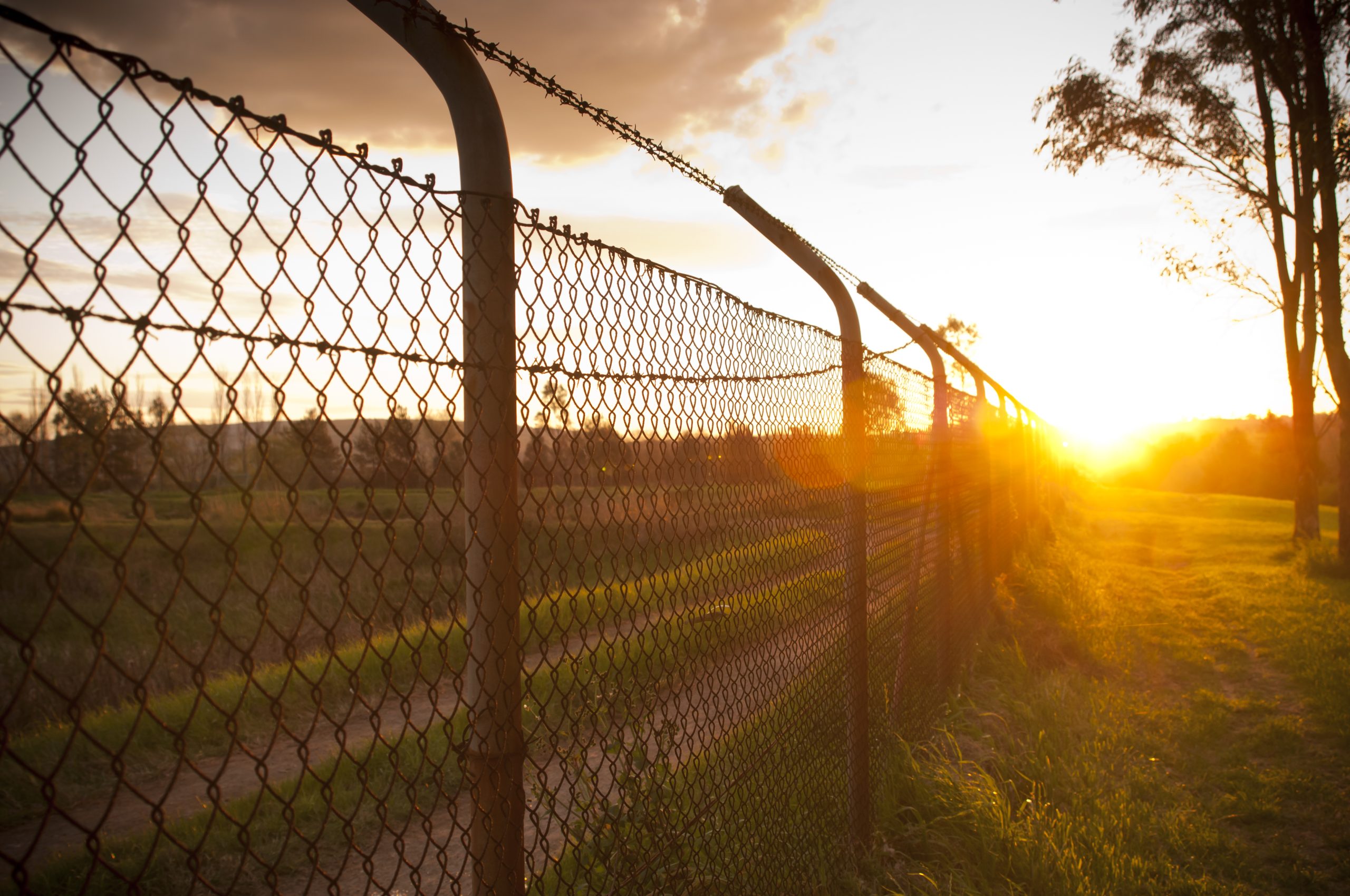 fence with a sunset in the background