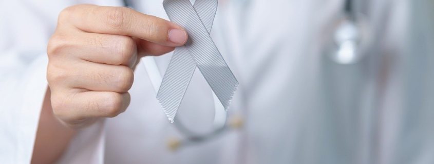 doctor holding a grey ribbon