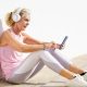 woman in workout gear on her phone learning remotely